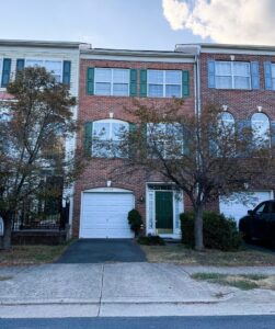 Townhouse located at 9994 Shortbread Way in Bristow, Virginia. The property is a three-story brick townhouse with a garage on the ground floor.